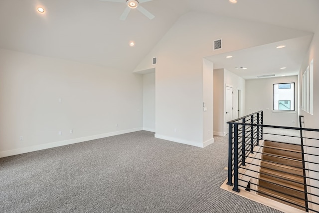 empty room with ceiling fan, high vaulted ceiling, and carpet floors