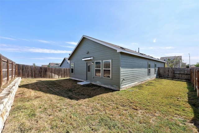 back of house with a lawn