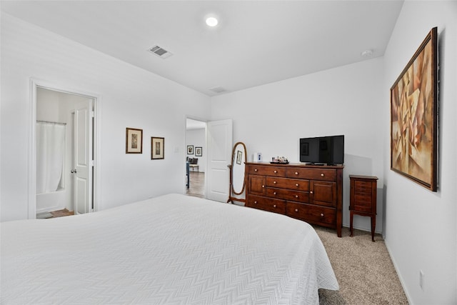 carpeted bedroom with ensuite bath