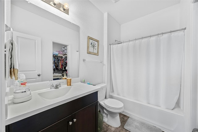 full bathroom featuring hardwood / wood-style floors, vanity, shower / tub combo, and toilet