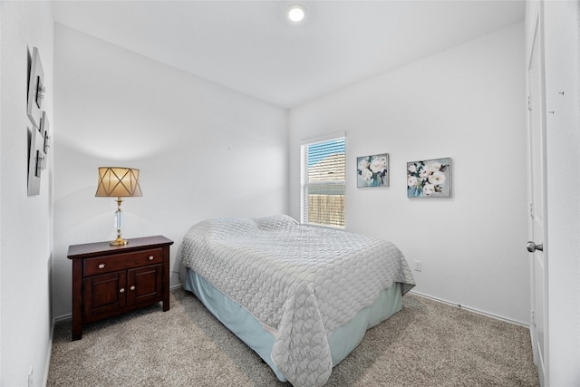 bedroom featuring light colored carpet and baseboards
