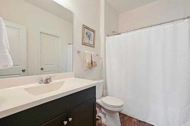 bathroom featuring wood finished floors, toilet, vanity, and a shower with shower curtain
