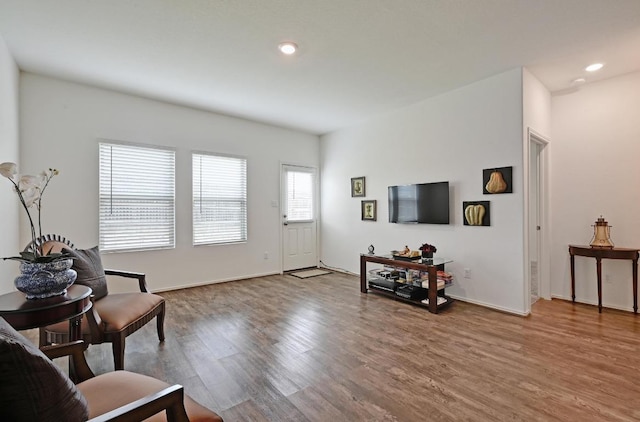living room with wood finished floors, recessed lighting, and baseboards