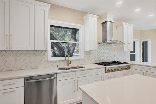 kitchen with appliances with stainless steel finishes, white cabinets, and a sink