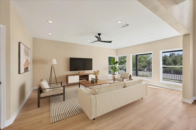 living room with ceiling fan and light wood-type flooring