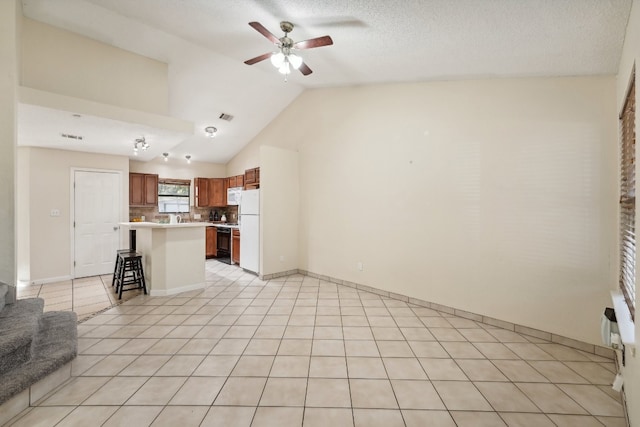 kitchen featuring a center island, white appliances, a breakfast bar, backsplash, and vaulted ceiling