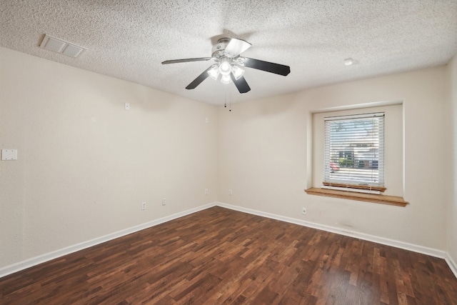 empty room featuring ceiling fan, dark hardwood / wood-style floors, and a textured ceiling