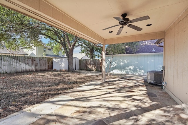 view of patio featuring ceiling fan, a storage unit, and central AC