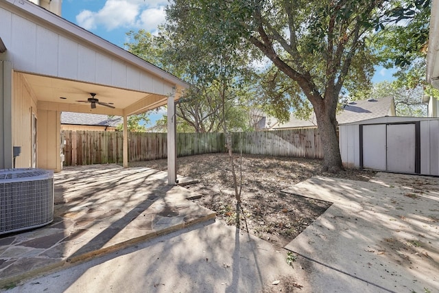 view of patio featuring ceiling fan, central AC unit, and a storage shed