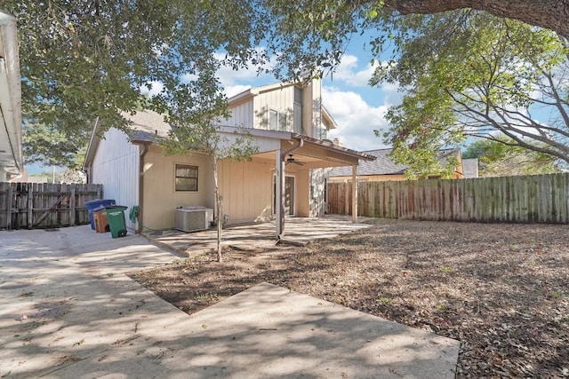 rear view of house with ceiling fan, central air condition unit, and a patio