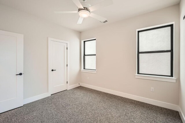 9031 Cattle Baron Path, Austin, TX 78747 - unfurnished bedroom featuring carpet floors, baseboards, and a ceiling fan