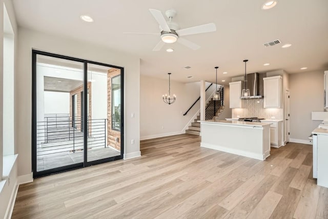 9031 Cattle Baron Path, Austin, TX 78747 - kitchen featuring wall chimney range hood, light wood-style flooring, light countertops, baseboards, and recessed lighting