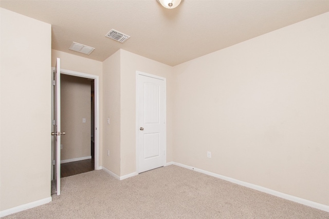 unfurnished bedroom with light colored carpet