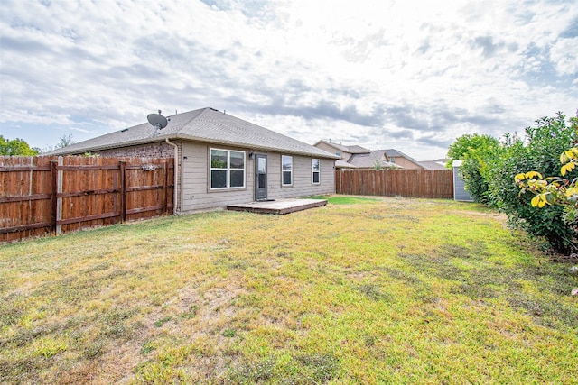 rear view of property featuring a yard