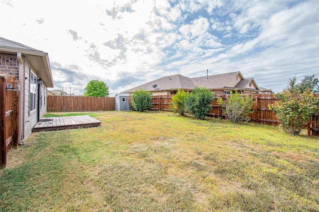 view of yard with a storage unit and a wooden deck