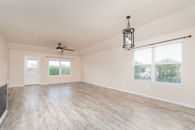 unfurnished living room featuring ceiling fan, light hardwood / wood-style floors, and vaulted ceiling