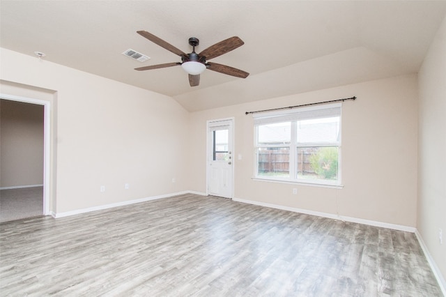 empty room featuring ceiling fan, light hardwood / wood-style floors, and lofted ceiling