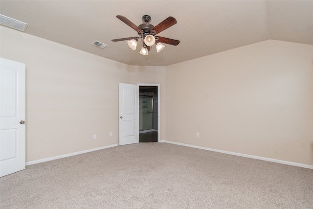 carpeted spare room with vaulted ceiling and ceiling fan