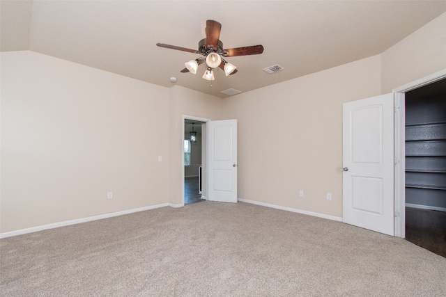 unfurnished bedroom with carpet flooring, ceiling fan, and lofted ceiling