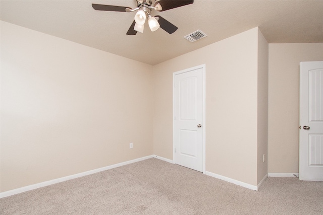 empty room featuring light carpet and ceiling fan