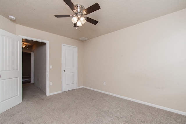 unfurnished bedroom featuring ceiling fan and light colored carpet