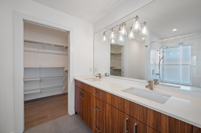 bathroom featuring an enclosed shower, vanity, and hardwood / wood-style floors