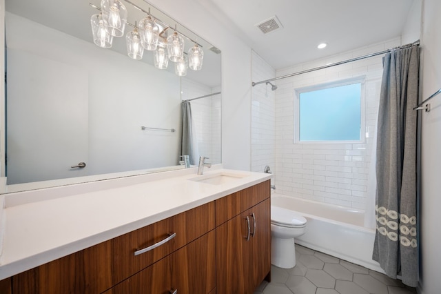 full bathroom featuring tile patterned flooring, vanity, toilet, and shower / tub combo with curtain