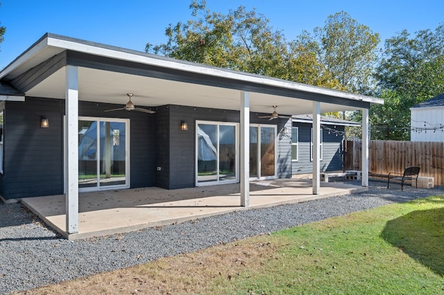 rear view of house featuring a patio area, a lawn, and ceiling fan