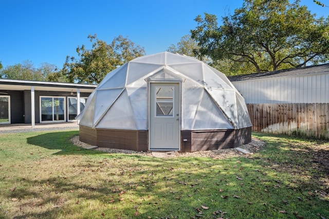 view of outbuilding featuring a lawn