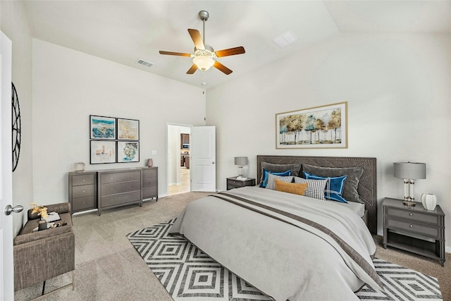 carpeted bedroom featuring vaulted ceiling and ceiling fan