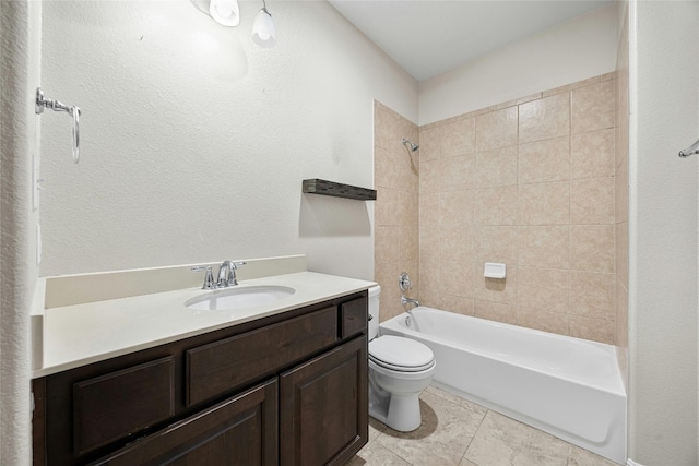 full bathroom featuring tile patterned flooring, tiled shower / bath, toilet, and vanity