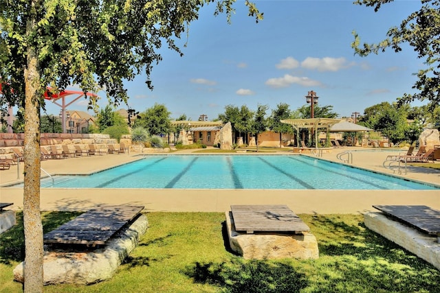 view of pool with a yard