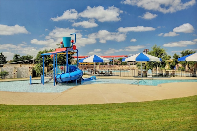 view of playground featuring a lawn and a community pool