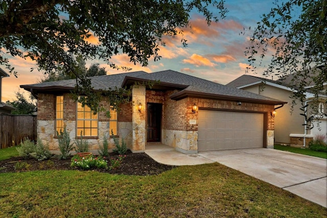 view of front of property featuring a garage and a lawn