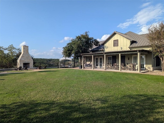 exterior space featuring exterior fireplace and a patio area