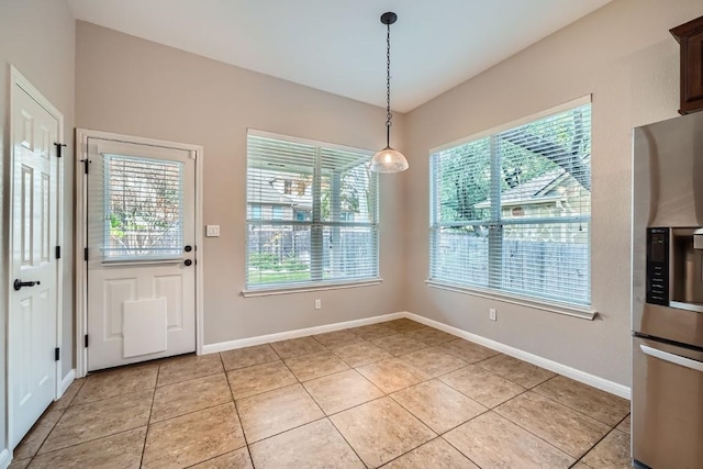 unfurnished dining area featuring plenty of natural light and light tile patterned flooring