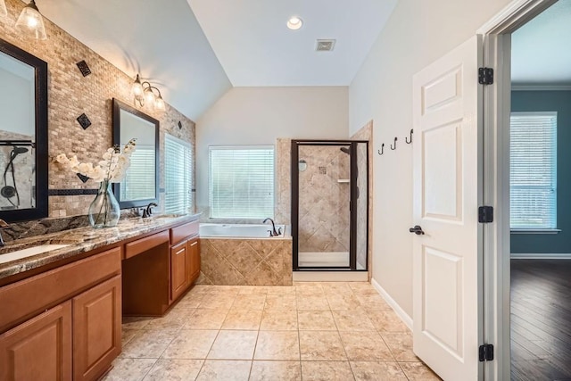 bathroom featuring hardwood / wood-style flooring, vanity, vaulted ceiling, and shower with separate bathtub