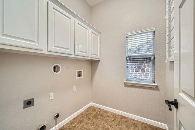 clothes washing area featuring electric dryer hookup, gas dryer hookup, hookup for a washing machine, and cabinets