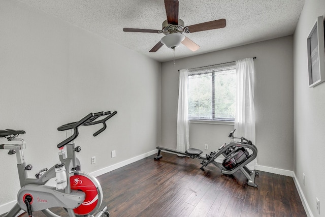 workout room with a textured ceiling, dark hardwood / wood-style floors, and ceiling fan