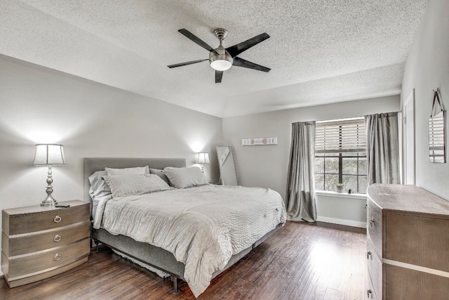 bedroom with dark hardwood / wood-style flooring, a textured ceiling, and ceiling fan