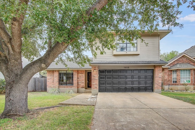 view of property with a front lawn and a garage