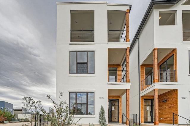 rear view of property featuring a balcony