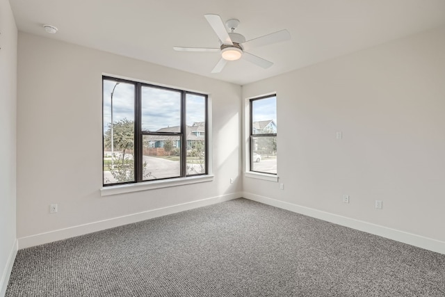 carpeted empty room featuring ceiling fan