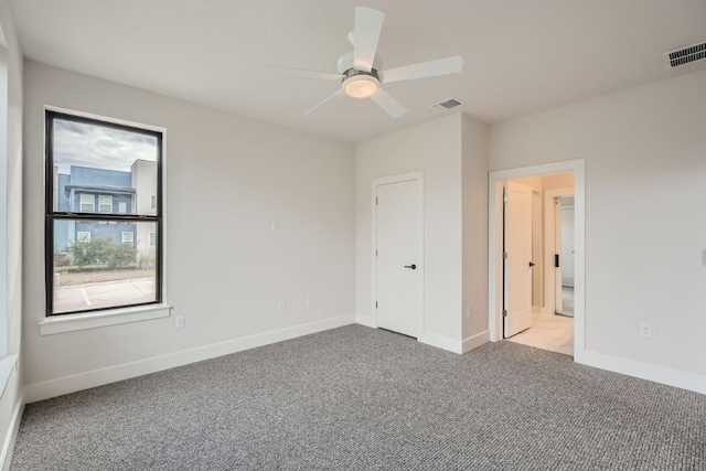 unfurnished bedroom featuring light colored carpet and ceiling fan