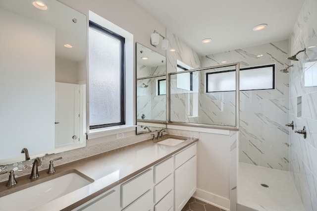 bathroom with vanity and tiled shower