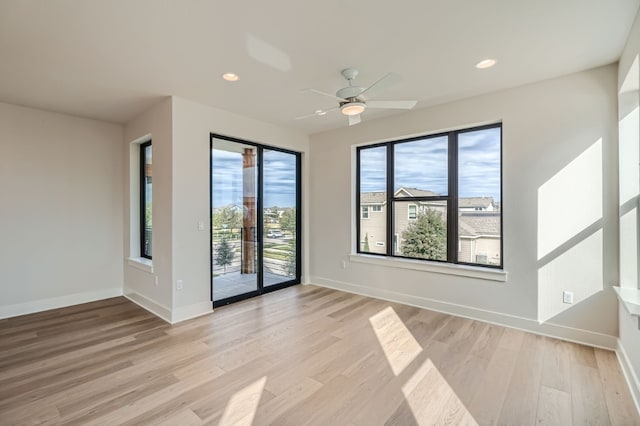 spare room with ceiling fan and light hardwood / wood-style flooring