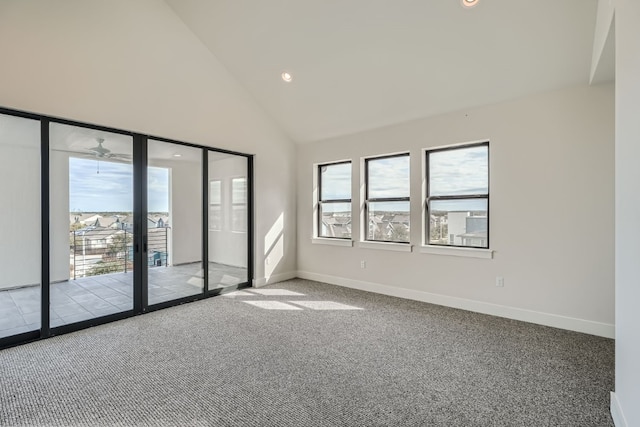 spare room with high vaulted ceiling and light colored carpet