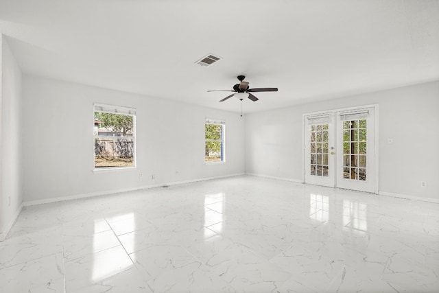 unfurnished room with french doors and ceiling fan