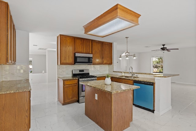 kitchen with stainless steel appliances, backsplash, decorative light fixtures, sink, and kitchen peninsula