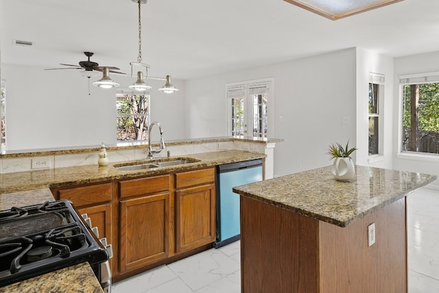 kitchen featuring hanging light fixtures, sink, a kitchen island with sink, stainless steel dishwasher, and black gas range oven